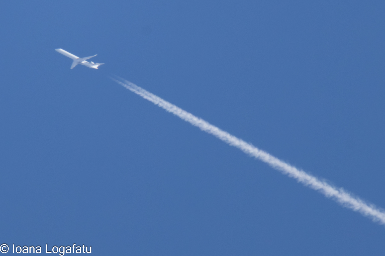 Plane gliding in a clear blue sky